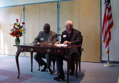 An historic agreement: Dr. Franklyn Jenifer of UTD (left) and Sam Roach of the CCCCD Board of Trustees.