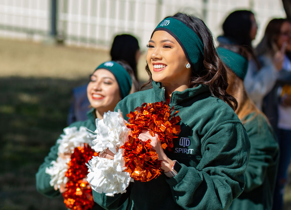 Speech-language pathology and audiology sophomore Kelsey Vong, a member of the UT Dallas Power Dancers, shows her Comet pride during the Homecoming Parade.