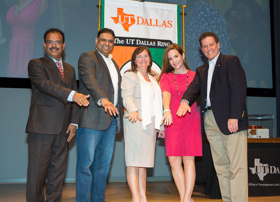 Graduates of the Executive MBA program Dinesh Donthula, Vinesh Reddy, Michelle Miller and Alan Plott gathered around Pamela Foster Brady EMBA'11 (center), executive director of the program, who also received a UT Dallas ring. Brady delayed getting hers for four years so she could share the occasion with the first class of students she recruited and guided through their entire EMBA experience.