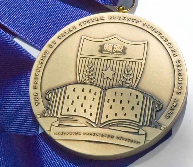 The ROTA medal, which includes an image of a book and UT seal and has a blue ribbon.