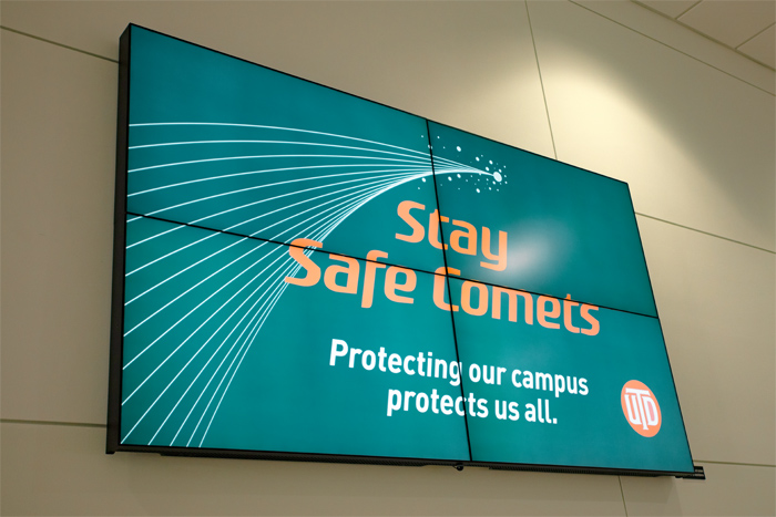 Digital sign reads Stay Safe Comets. Protecting our campus protects us all.
