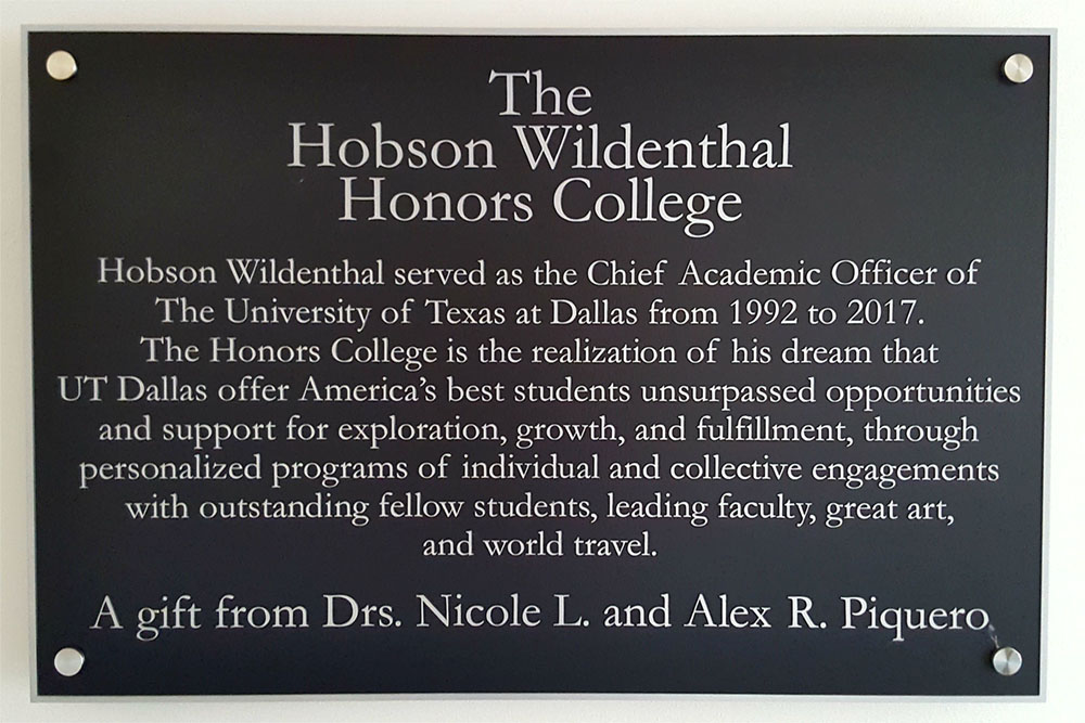 Plaque marking the The Hobson Wildenthal Honors College. A gift from Drs. Nicole L. and Alex R. Piquero.