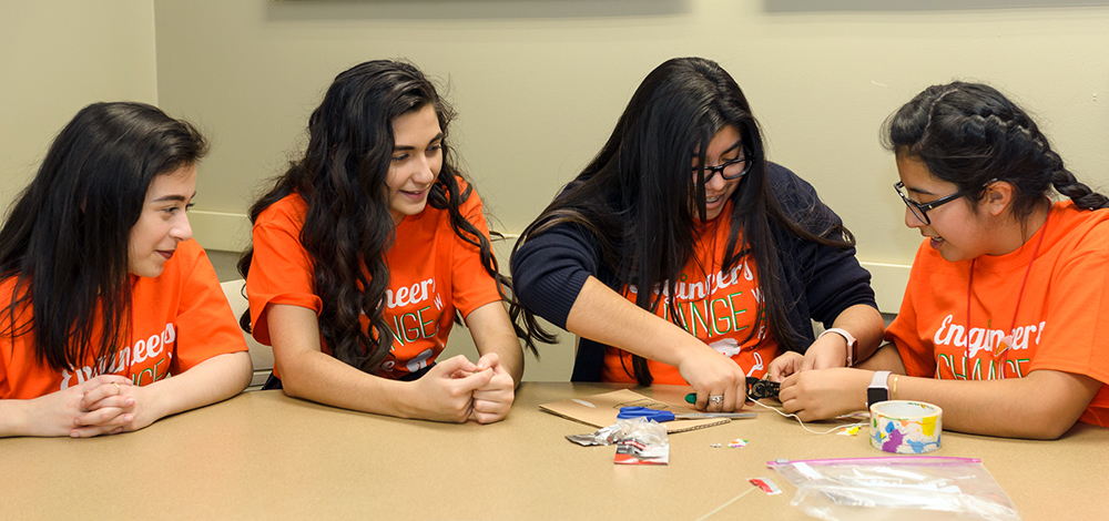 From left:  Leslie Lemus, Gaby Hernandez, Maria Lopez and Kristen Herrera, all students at Irma Lerma Rangel Young Womens Leadership School in Dallas, have fun building a safety alarm for joggers at Introduce a Girl to Engineering Day at UT Dallas.