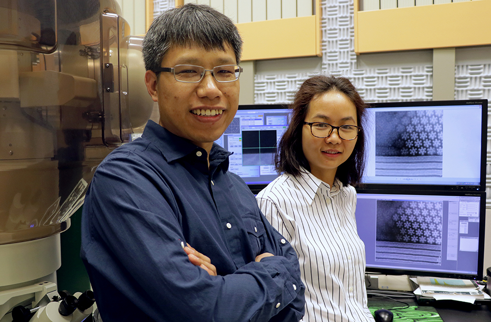 Qingxiao Wang (left) and Hui Zhu, both graduate students in materials science and engineering at The University of Texas at Dallas, used a transmission electron microscope to observe an unexpected phenomenon on the atomic scale (shown on the computer screens) in a material that might be suitable to power next-generation electronics.