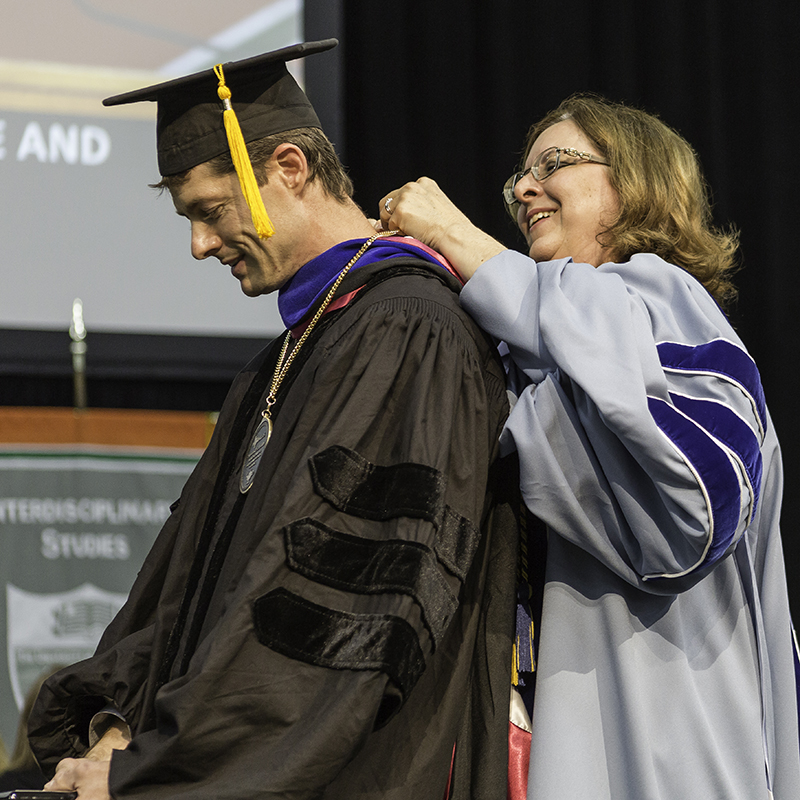 Dr. Jonathan Ploski, an assistant professor in the School of Behavioral and Brain Sciences, receives the 2017 Provost Award for Faculty Excellence in Undergraduate Research Mentoring from Interim Provost Dr. Inga Musselman at the May 10 Honors Convocation.
