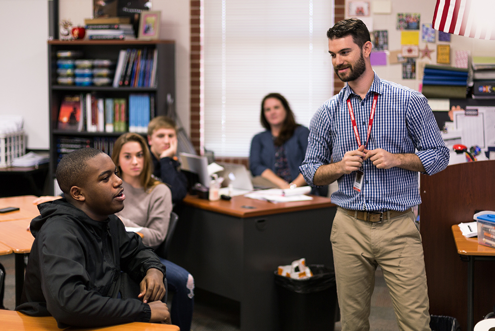 Brett Reisman, a student teacher at Lovejoy High School in Lucas this fall, listens as student James Rainey answers a question during a Jeopardy-style review for U.S. history.