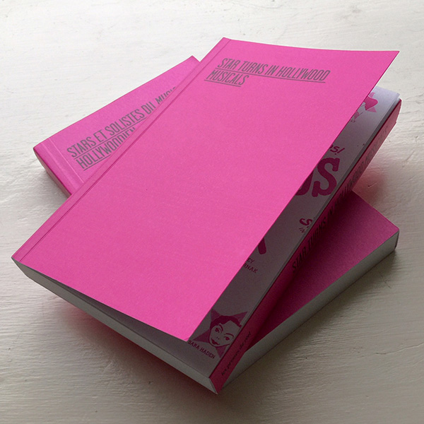 two copies of the book Star Turns in Hollywood Musicals with bright pink cover