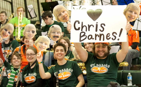 Fans cheering on Chris Barnes at a basketball game