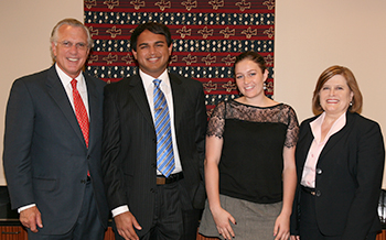 Richard Fisher poses with McDermott Scholars and JSOM students Siddharth Nivas and Zoe Wilson, and JSOM alumnus Ann Worthy.